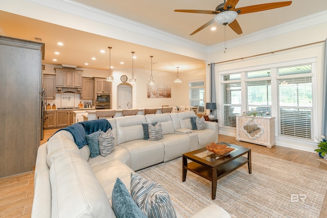 living room featuring ceiling fan and ornamental molding