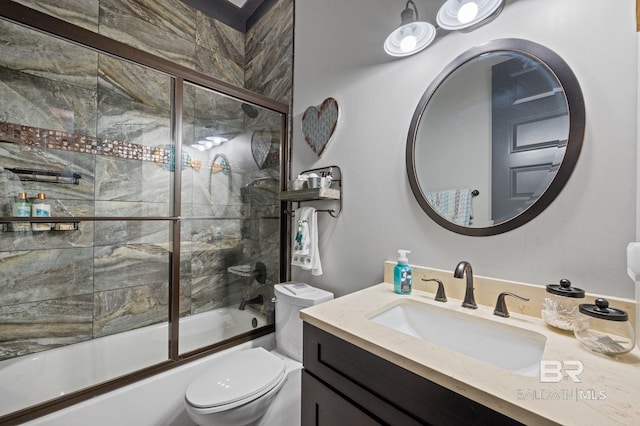 full bathroom featuring enclosed tub / shower combo, vanity, and toilet