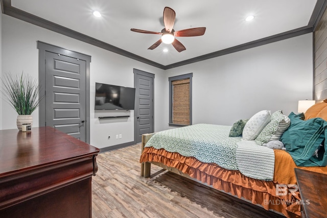 bedroom featuring ceiling fan, ornamental molding, and hardwood / wood-style flooring