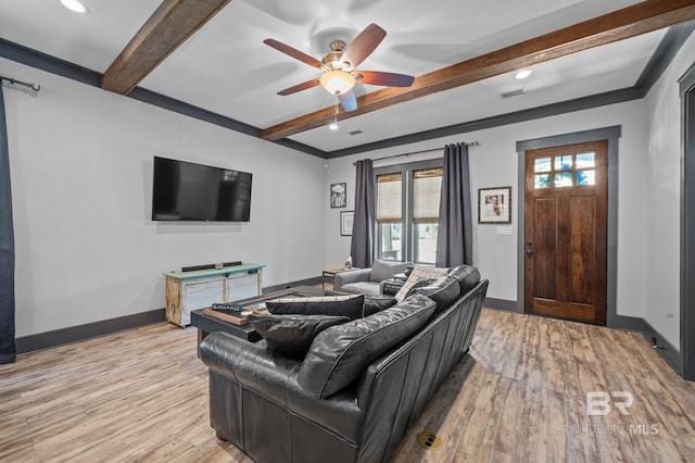 living room with beamed ceiling, hardwood / wood-style floors, and ceiling fan