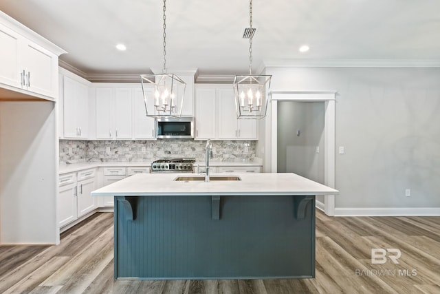 kitchen featuring appliances with stainless steel finishes, light wood-type flooring, and tasteful backsplash