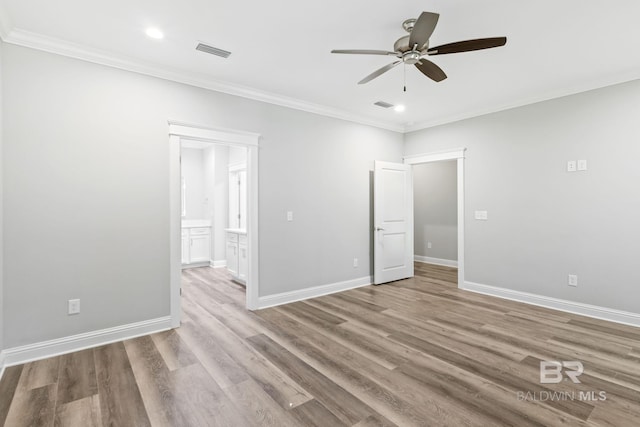 spare room featuring ceiling fan, crown molding, and wood-type flooring