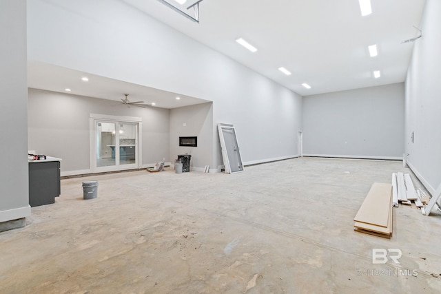 unfurnished living room featuring ceiling fan