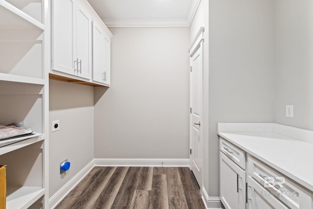 washroom featuring electric dryer hookup, crown molding, and dark hardwood / wood-style flooring