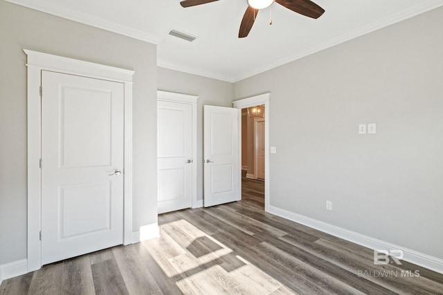 unfurnished bedroom with ceiling fan, crown molding, and wood-type flooring