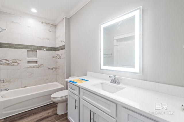 full bathroom featuring hardwood / wood-style flooring, tiled shower / bath, toilet, vanity, and ornamental molding