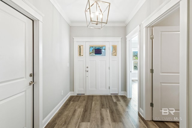 foyer with a notable chandelier, crown molding, and wood-type flooring