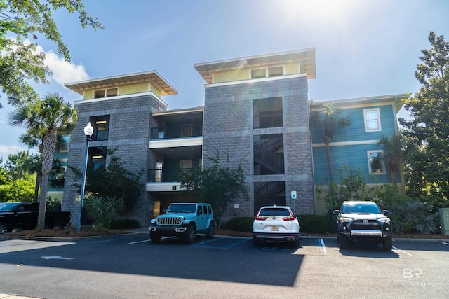 1430 Regency Rd Unit J302, Gulf Shores, AL 36542 - view of property featuring uncovered parking