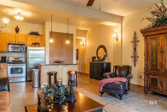 1430 Regency Rd Unit J302, Gulf Shores, AL 36542 - tiled living room with ceiling fan and baseboards