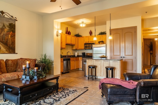 1430 Regency Rd Unit J302, Gulf Shores, AL 36542 - tiled living room with ceiling fan and a sink