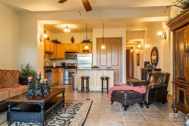 1430 Regency Rd Unit J302, Gulf Shores, AL 36542 - tiled living area featuring a sink and ceiling fan