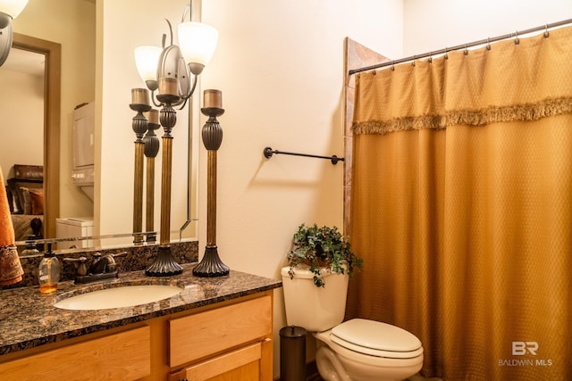 1430 Regency Rd Unit J302, Gulf Shores, AL 36542 - full bathroom featuring toilet, stacked washer and clothes dryer, vanity, and a shower with shower curtain