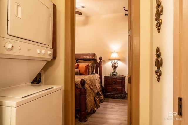 1430 Regency Rd Unit J302, Gulf Shores, AL 36542 - washroom featuring stacked washer / dryer and light wood-type flooring