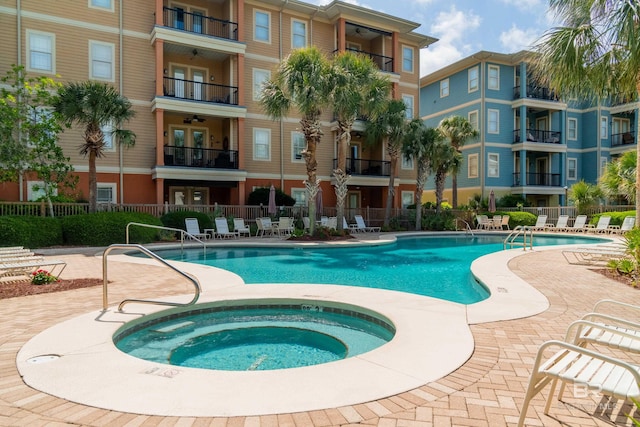 1430 Regency Rd Unit J302, Gulf Shores, AL 36542 - community pool featuring ceiling fan, fence, a hot tub, and a patio