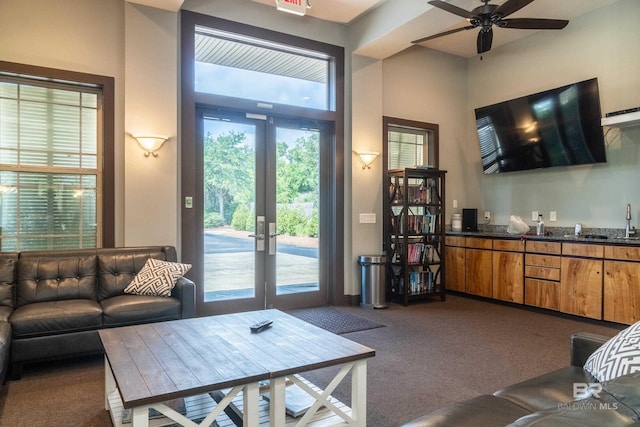 1430 Regency Rd Unit J302, Gulf Shores, AL 36542 - living room featuring dark colored carpet, french doors, and a ceiling fan