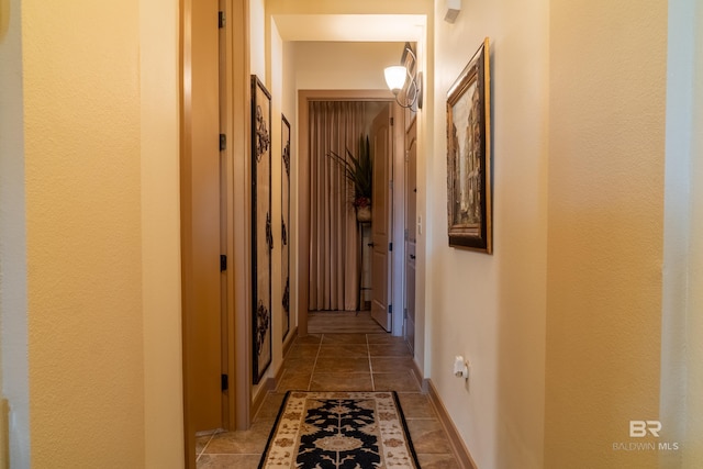 1430 Regency Rd Unit J302, Gulf Shores, AL 36542 - hallway with baseboards and light stone finish flooring