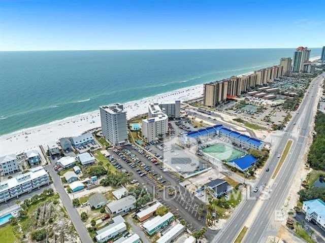 drone / aerial view featuring a water view and a beach view