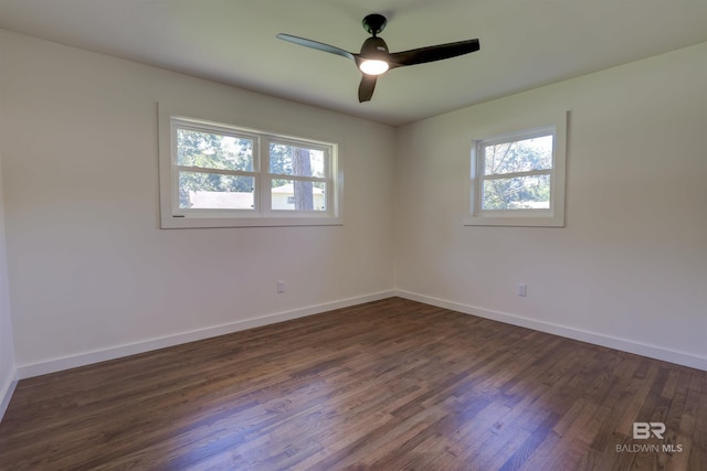 spare room featuring dark hardwood / wood-style floors and ceiling fan