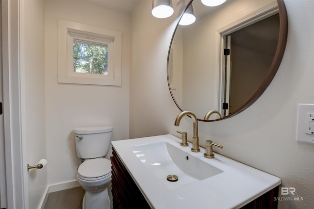 bathroom featuring toilet and vanity