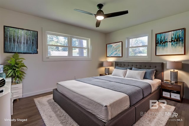 bedroom with ceiling fan and dark hardwood / wood-style floors