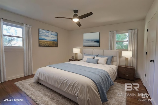 bedroom featuring dark hardwood / wood-style flooring and ceiling fan