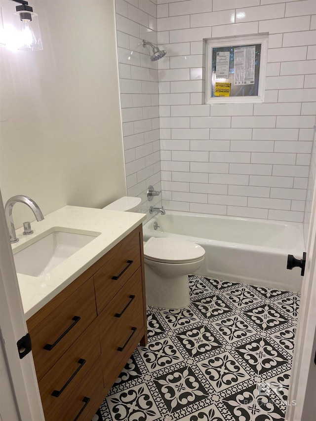 full bathroom with tiled shower / bath combo, toilet, tile patterned flooring, and vanity