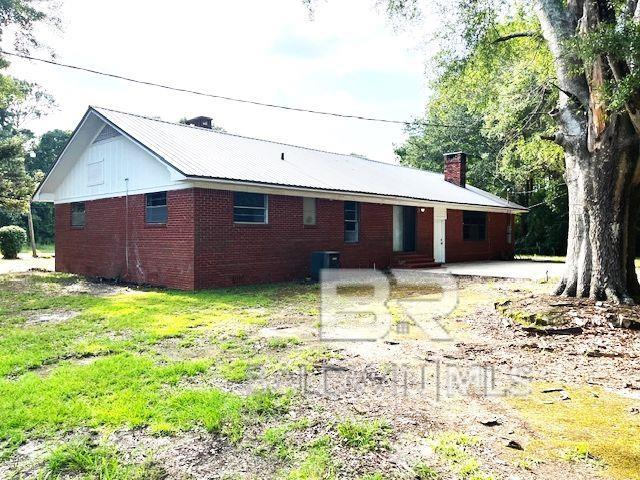 back of property featuring a patio and central AC