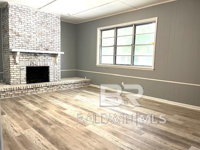 unfurnished living room featuring hardwood / wood-style floors and a fireplace