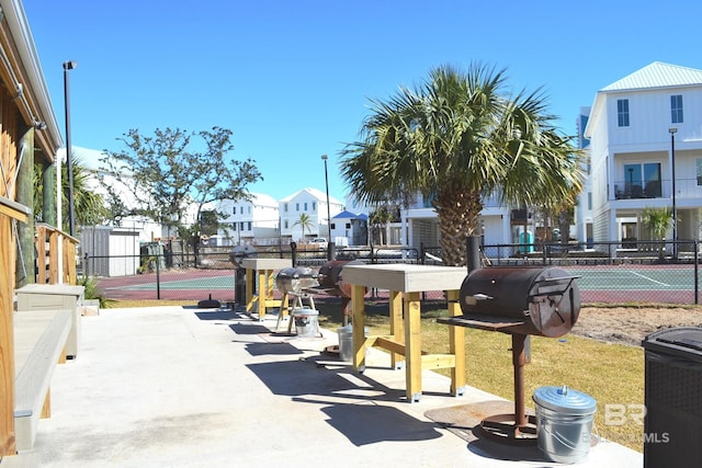 view of property's community with tennis court