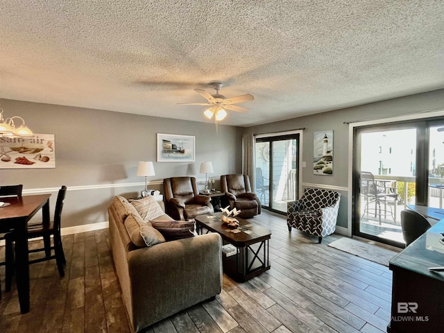 living room with wood-type flooring, a textured ceiling, and ceiling fan