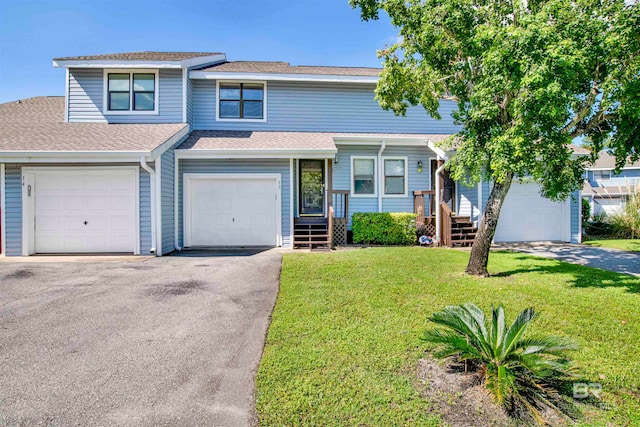 view of front of house featuring a garage and a front lawn