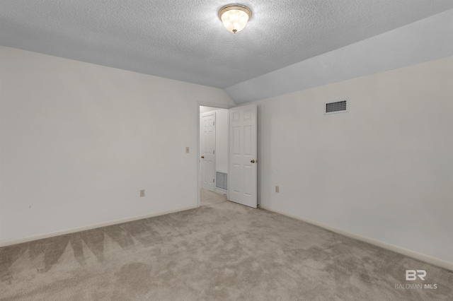 143 Kingswood Dr, Daphne, AL 36526 - empty room featuring carpet, vaulted ceiling, and a textured ceiling