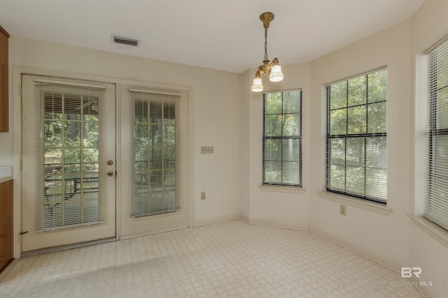 143 Kingswood Dr, Daphne, AL 36526 - unfurnished dining area featuring tile patterned floors and a chandelier