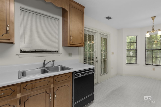 143 Kingswood Dr, Daphne, AL 36526 - kitchen with black dishwasher, brown cabinets, light countertops, hanging light fixtures, and light floors