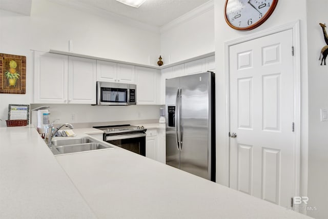 kitchen with white cabinets, sink, ornamental molding, a textured ceiling, and appliances with stainless steel finishes