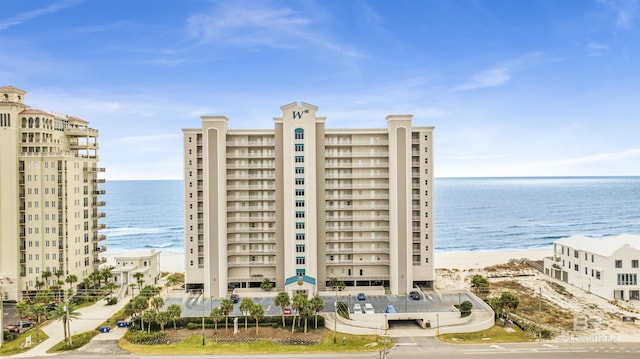 view of property with a beach view and a water view