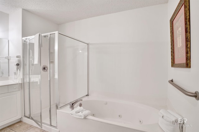 bathroom with tile patterned floors, vanity, separate shower and tub, and a textured ceiling