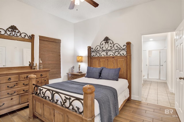 bedroom with a textured ceiling, light wood-type flooring, ensuite bathroom, and ceiling fan