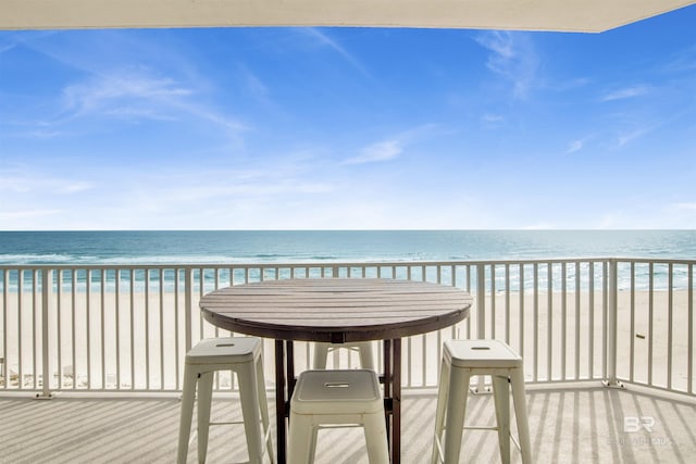 balcony with a view of the beach and a water view