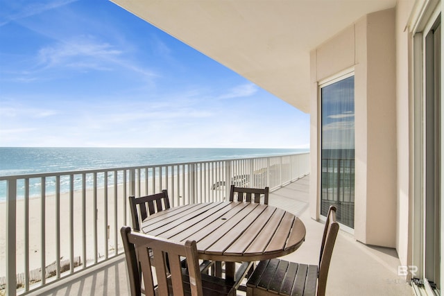 balcony featuring a beach view and a water view