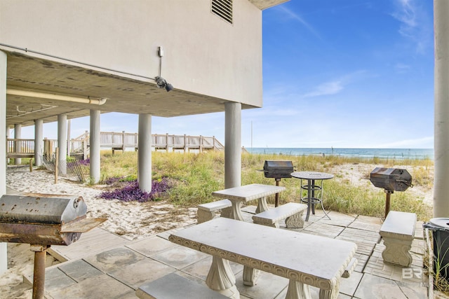 view of patio with a water view