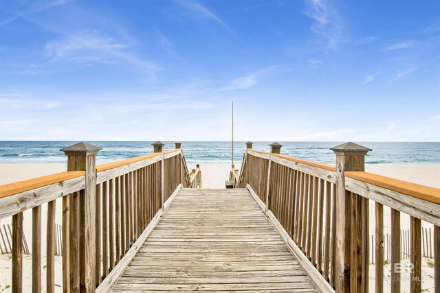 view of property's community featuring a water view and a view of the beach