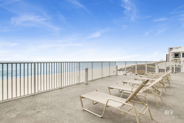 view of patio with a view of the beach and a water view