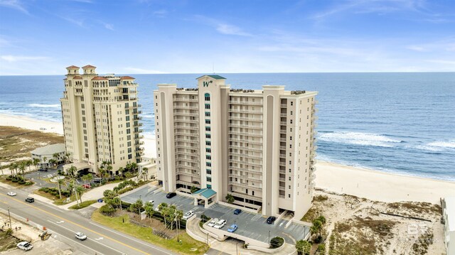 birds eye view of property featuring a water view and a beach view