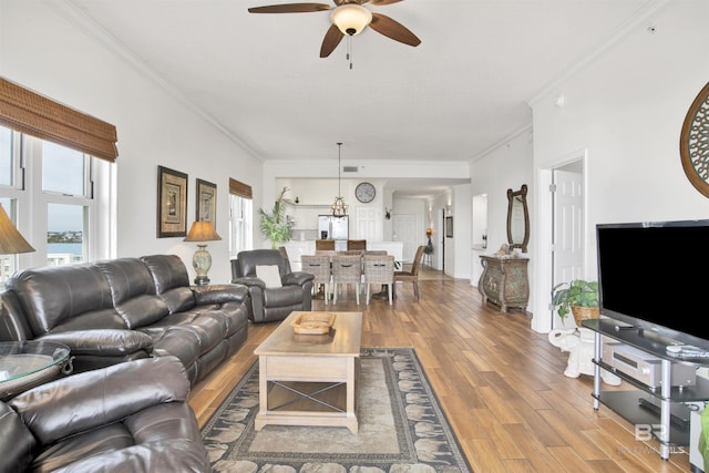 living room with crown molding, ceiling fan, and hardwood / wood-style flooring