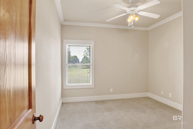 unfurnished room featuring light colored carpet, crown molding, baseboards, and ceiling fan