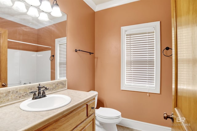 bathroom featuring toilet, vanity, and a shower