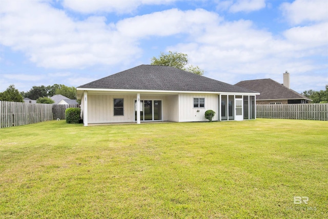rear view of house with roof with shingles and a sunroom