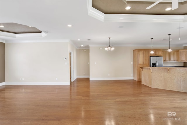 unfurnished living room with ornamental molding, a raised ceiling, light wood-style flooring, ceiling fan, and baseboards