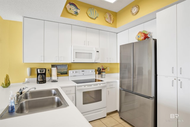 kitchen featuring sink, white cabinets, and white appliances